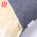 Close up detail of the grey outer cover of a luxury dog Snuggle Bed and the cream faux-fur fleece lining with designer brand label for Charley Chau.