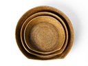 Three round rattan dog baskets nested together viewed from above.